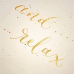 handwritten calligraphy saying and relax in&nbsp;gold